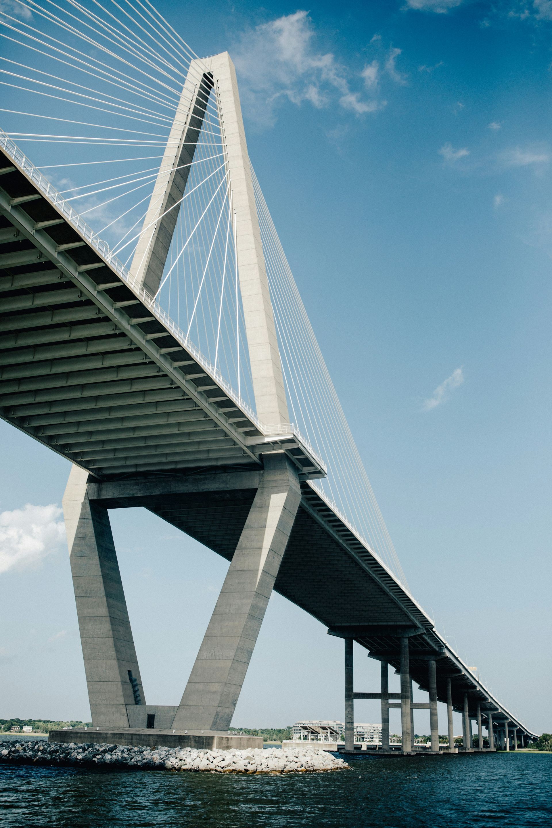 A bridge over a body of water with a blue sky in the background