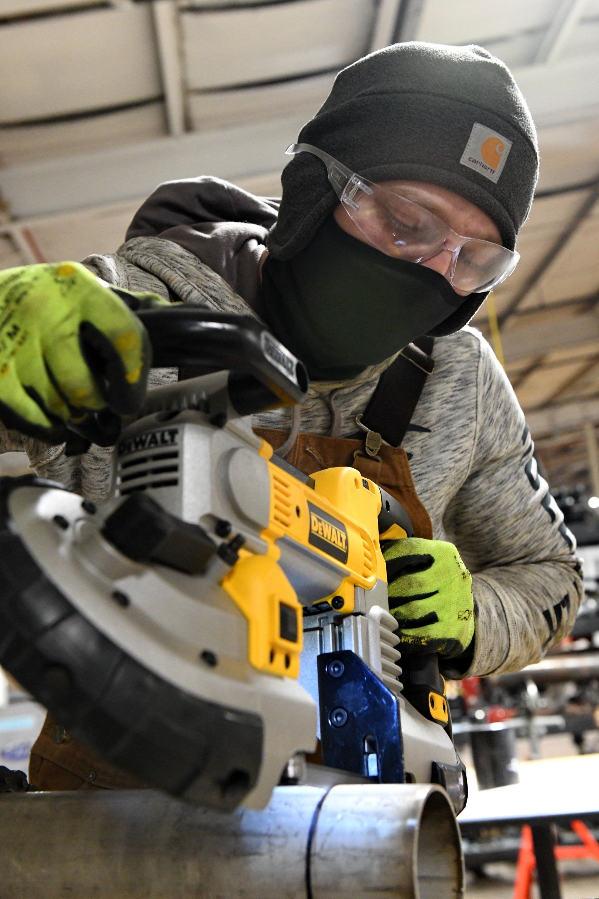 Local 538 Apprentice using metal saw to cut a steel pipe