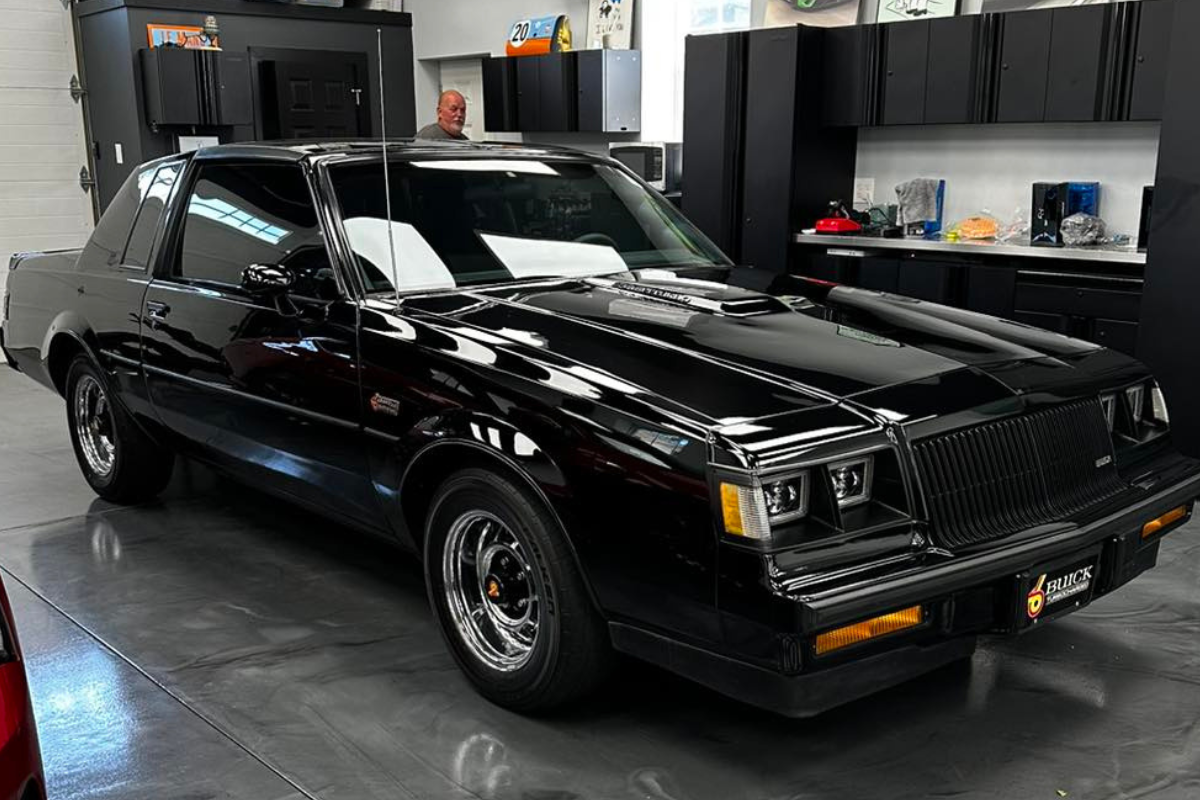 A black car is parked in a garage.