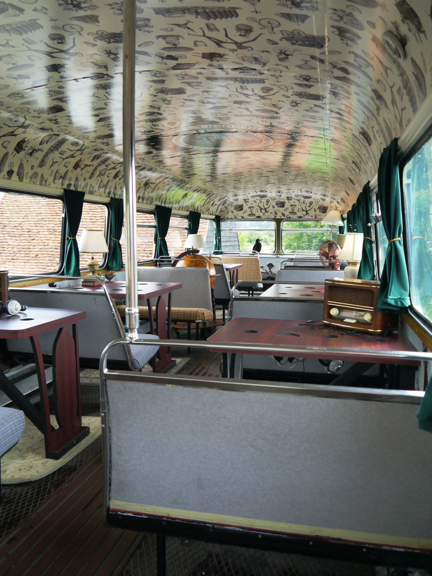 the inside of a bus with tables and chairs