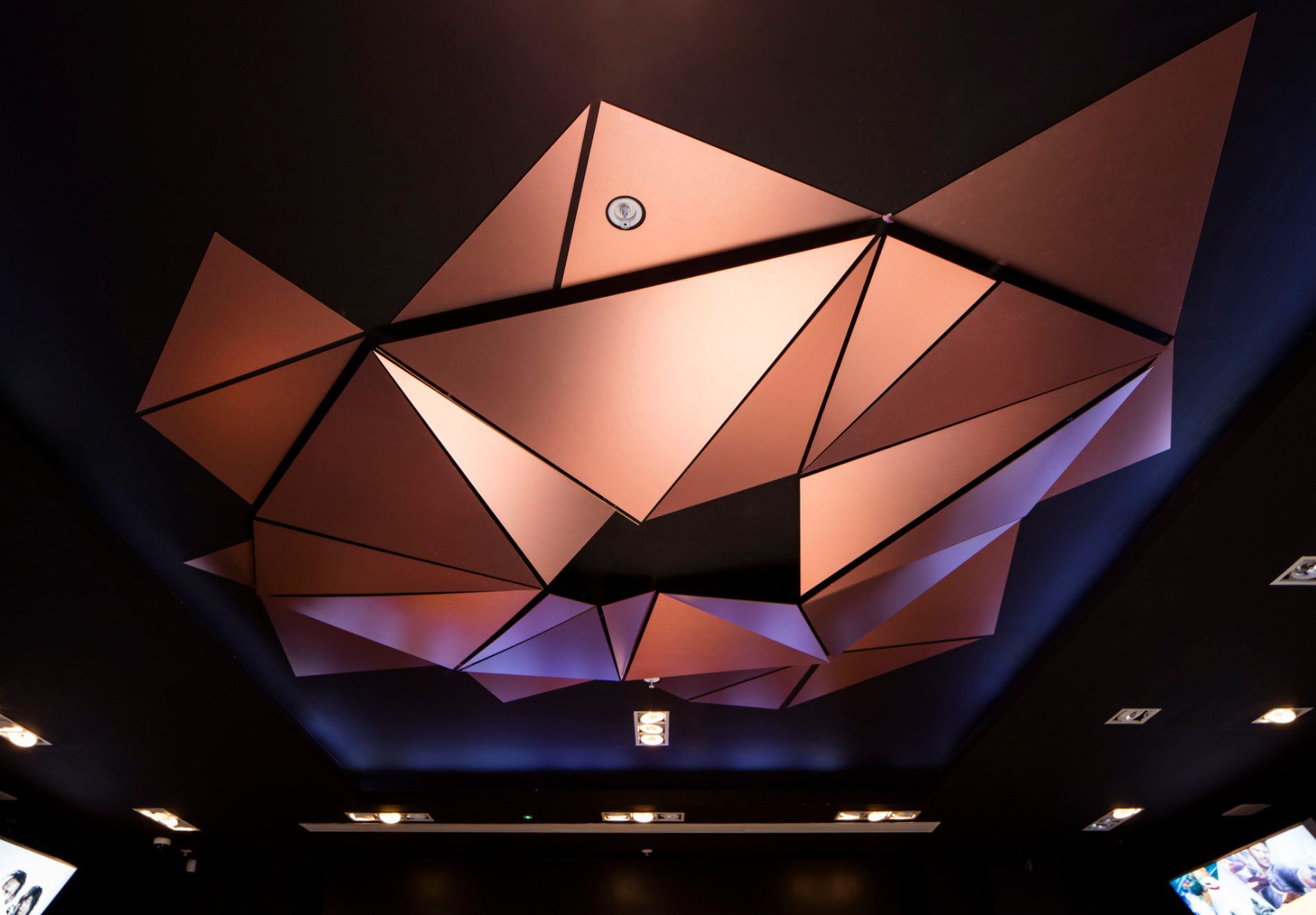a ceiling with a geometric design made of triangles