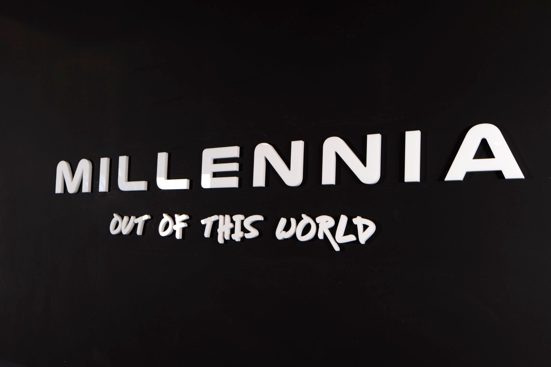 millennia out of this world is written in white on a black background