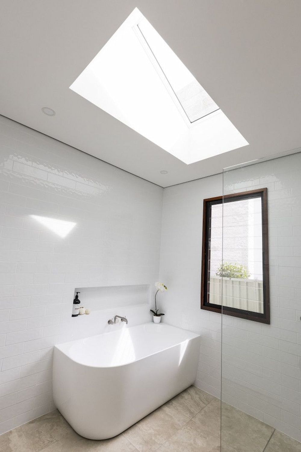 A Bathroom With A Bathtub And A Skylight Above It — Matt Loder Constructions in Bulli, NSW