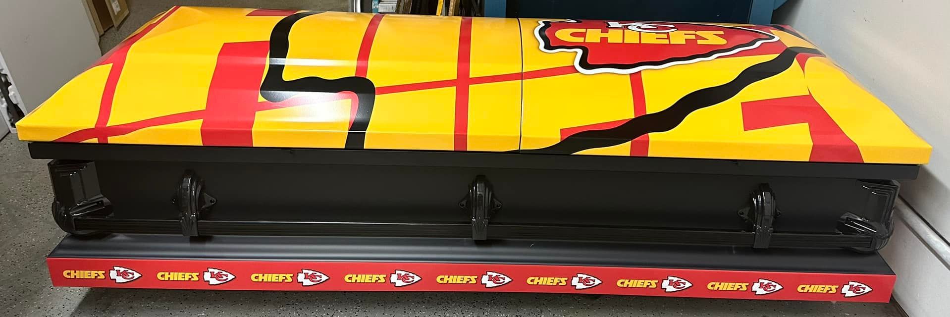A coffin painted in Kansas City Chiefs colors and logo.