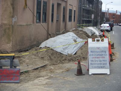 A sign on the side of the road says waterproofing and insurance co.