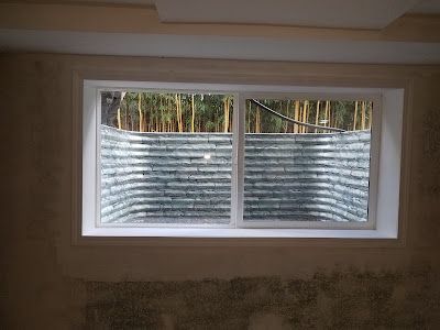 A window in a room with a fence in the background