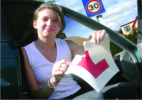 A woman tearing up her L-plate