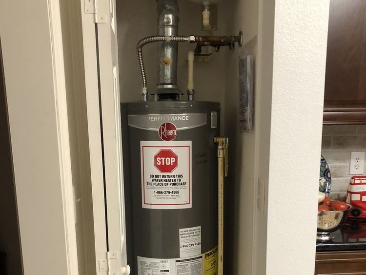 a water heater with a stop sign on it