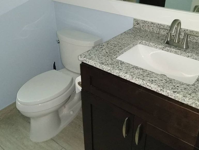 a bathroom with a toilet a sink and a mirror