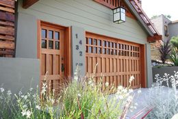 A house with a wooden garage door and a lantern