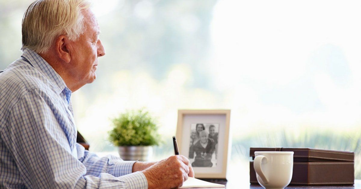 grieving man writing a letter - Philip J. Brendese Funeral Home