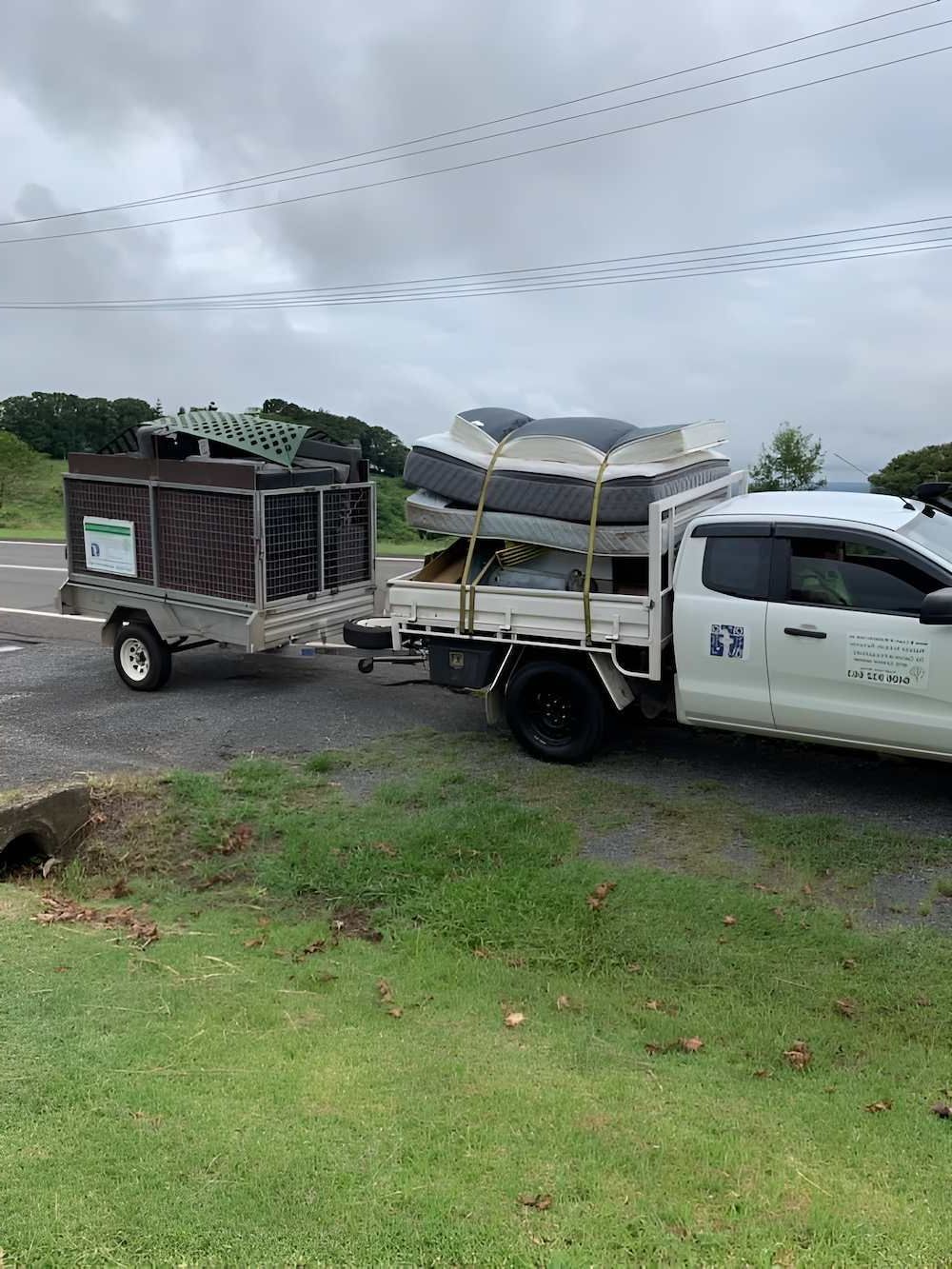 A Truck is Towing a Trailer With a Boat on It — A Load of Rubbish In Buderim, QLD