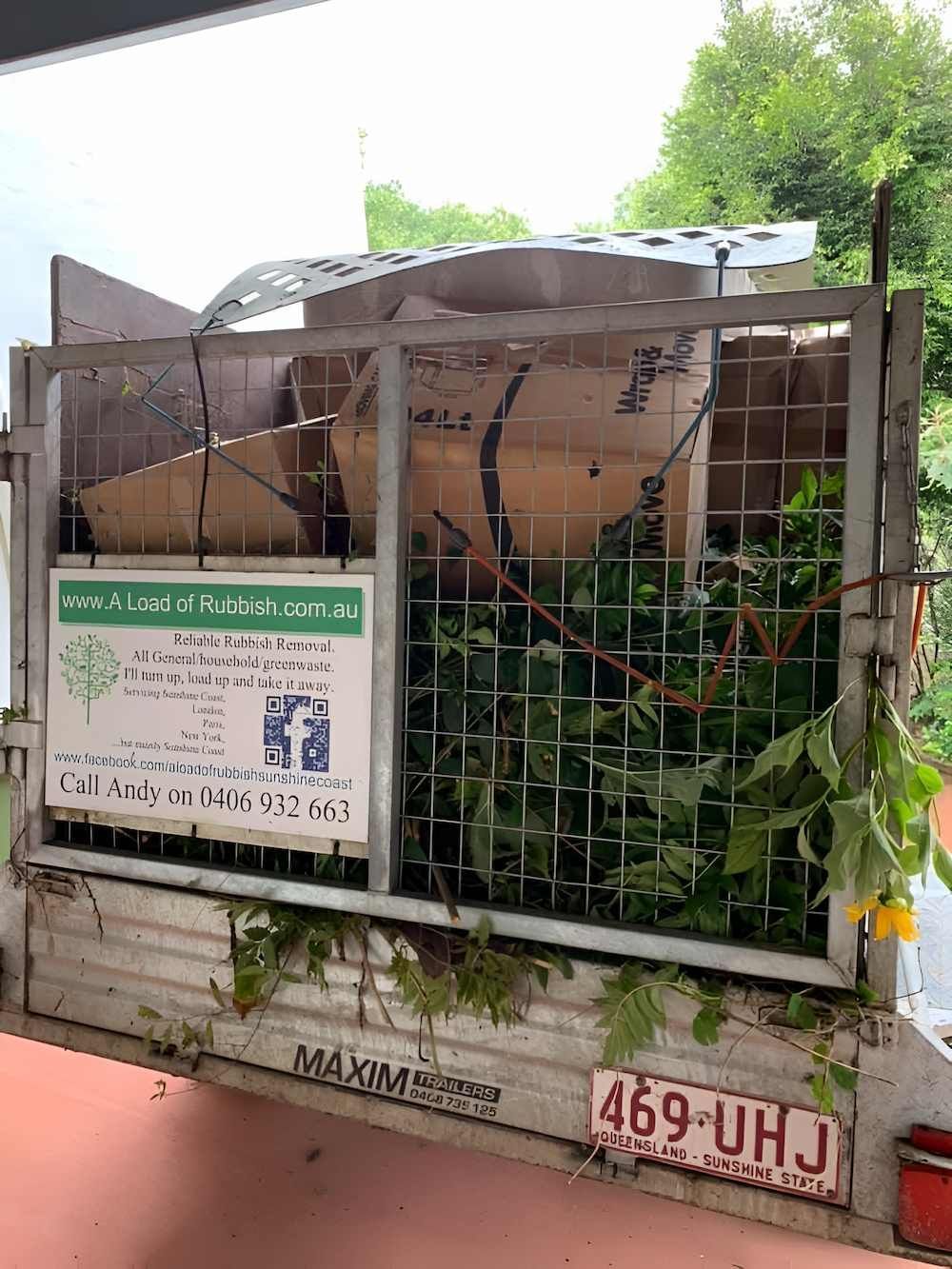 A Truck With a Sign on the Back of It Filled With Plants — A Load of Rubbish In Maroochydore, QLD