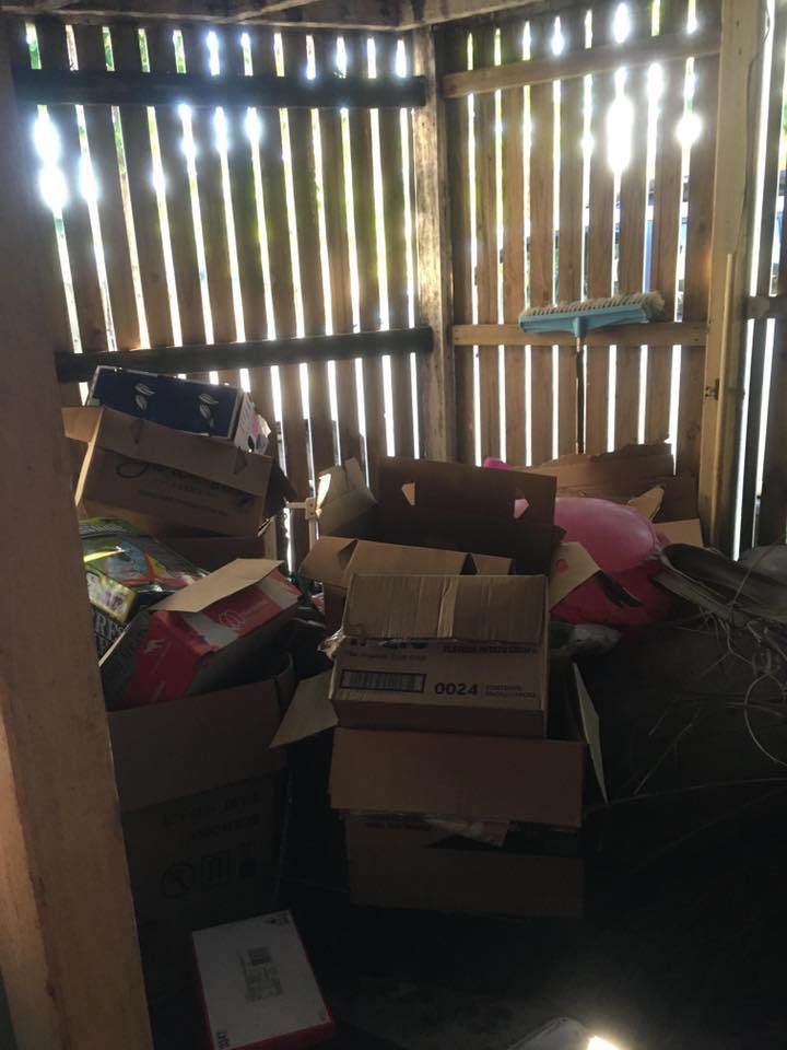 A Pile of Cardboard Boxes in a Wooden Shed — A Load of Rubbish In Buderim, QLD