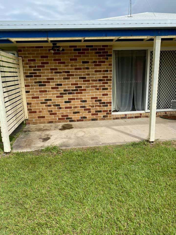 A Brick House With a Blue Roof and a Patio in Front of It — A Load of Rubbish In Buderim, QLD