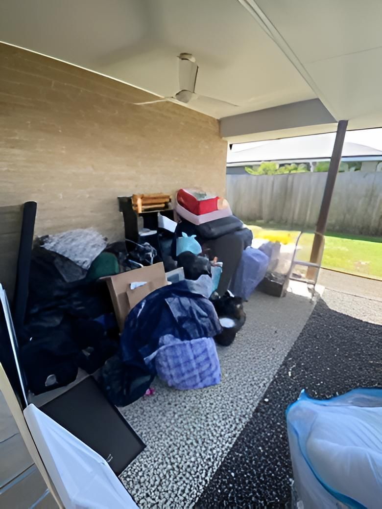 A Pile of Junk is Sitting on the Ground Outside of a House — A Load of Rubbish In Buderim, QLD