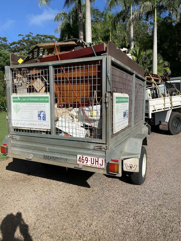 A Trailer Filled With Junk is Parked Next to a Truck — A Load of Rubbish In Buderim, QLD