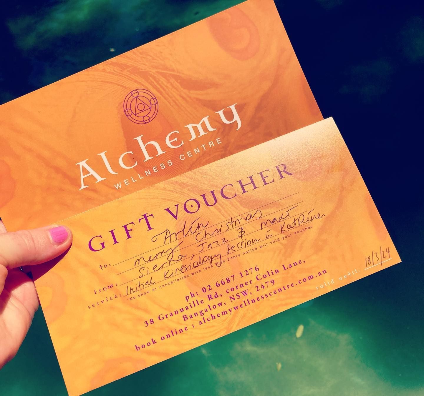 A Person is Holding a Gift Voucher for Alchemy Wellness Centre — Alchemy Wellness Centre In Bangalow, NSW