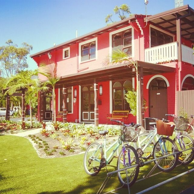 A Row of Bikes Are Parked in Front of A Red House — Alchemy Wellness Centre In Bangalow, NSW