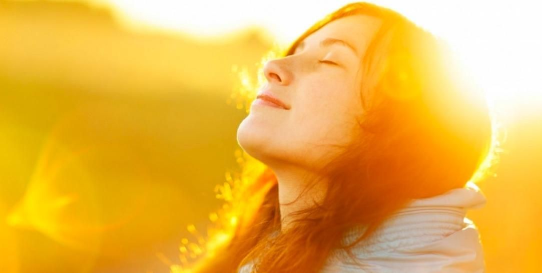A Woman Is Looking up At the Sun with Her Eyes Closed — Alchemy Wellness Centre In Bangalow, NSW