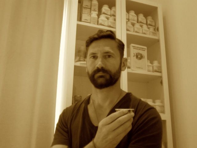 A Man with A Beard Is Standing in Front of A Medicine Cabinet — Alchemy Wellness Centre In Bangalow, NSW