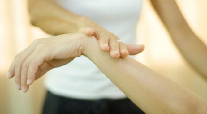 A Woman Is Holding Another Woman's Wrist — Alchemy Wellness Centre In Bangalow, NSW