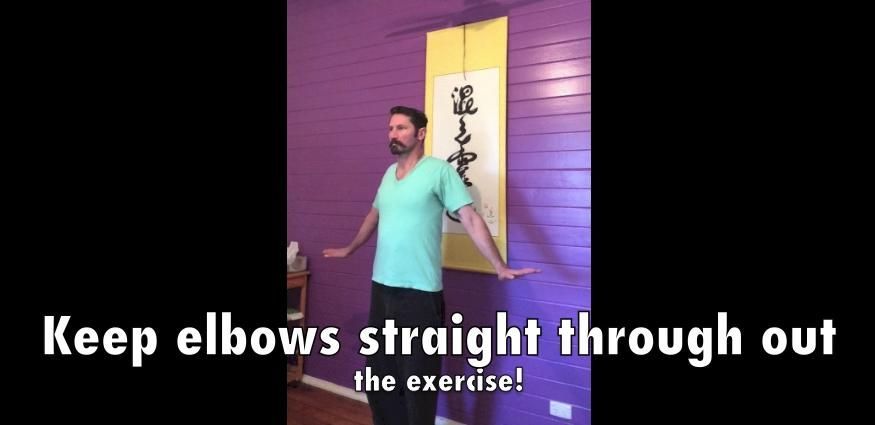 A Man Is Standing in Front of A Purple Wall with His Arms Outstretched — Alchemy Wellness Centre In Bangalow, NSW