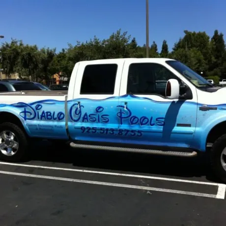 White pickup truck with blue water graphic and 