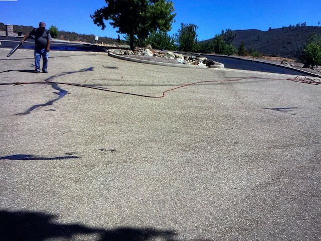 Man walking on cracked pavement; sunny outdoor scene.