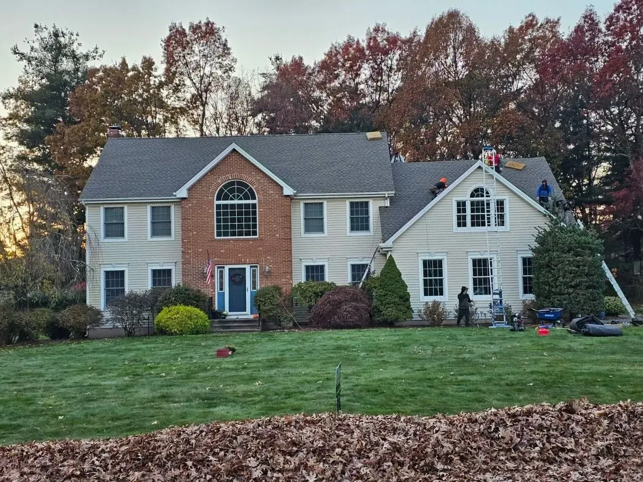 A large house with a roof that is being repaired