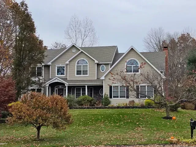 A large house with a large lawn in front of it.