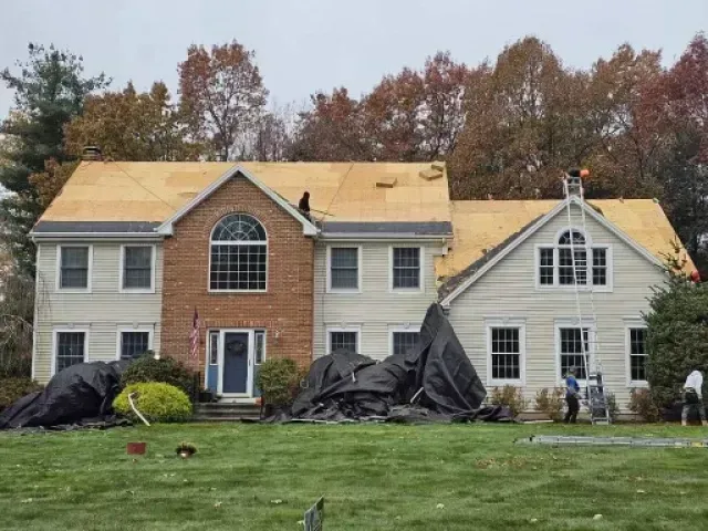 A large house with a roof that is being installed.