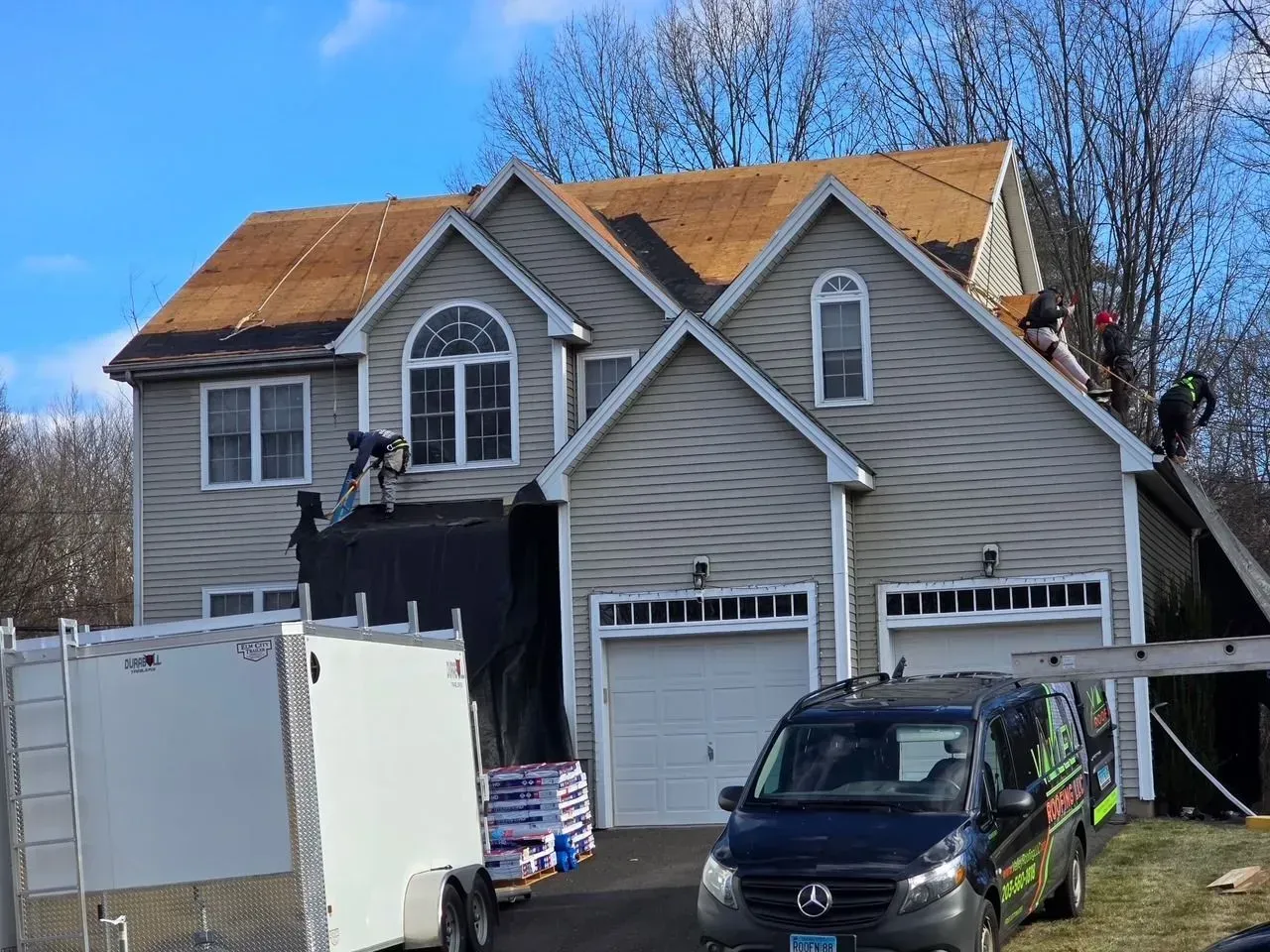 A large house with a car parked in front of it.