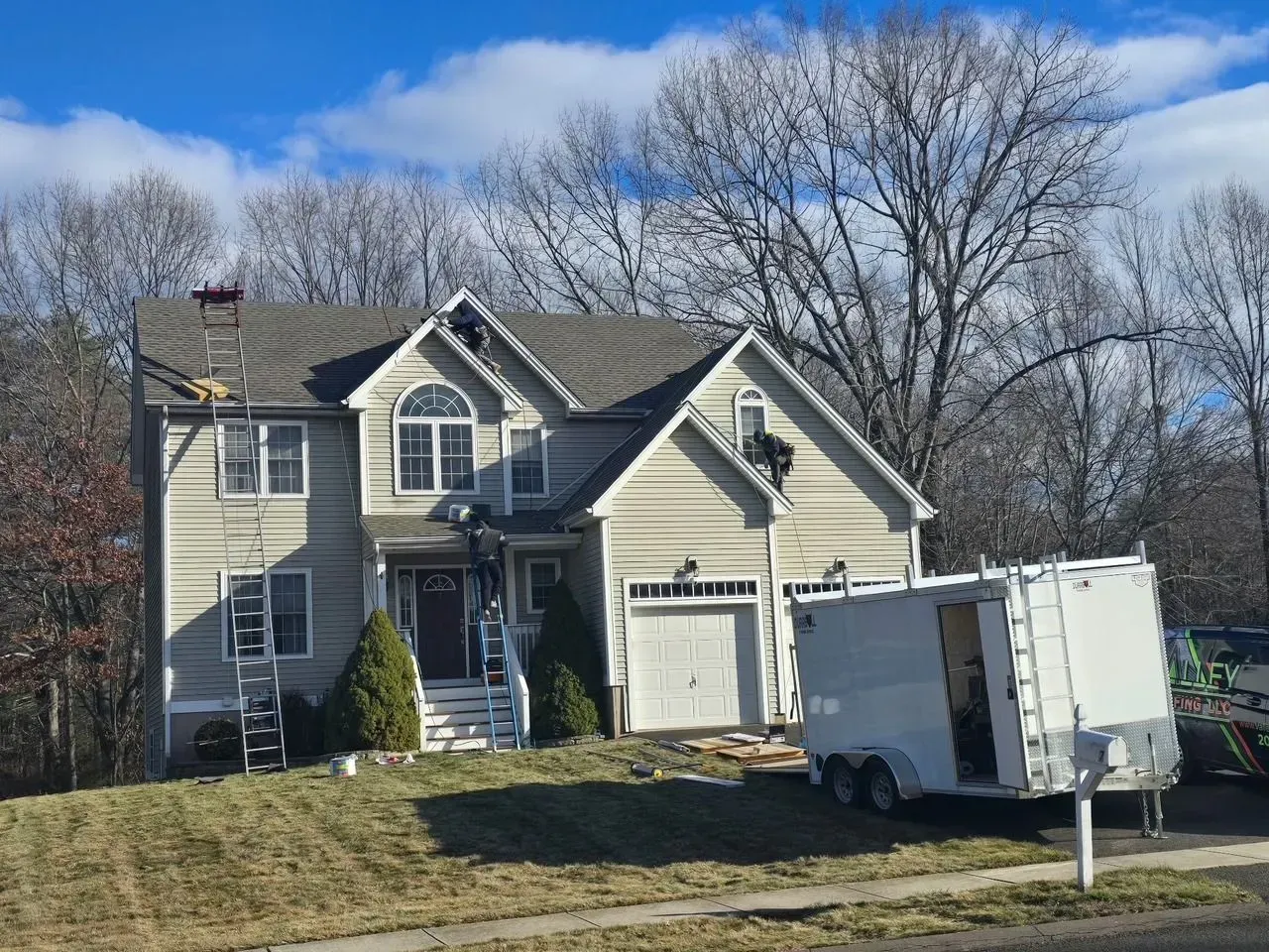 A house with a trailer parked in front of it