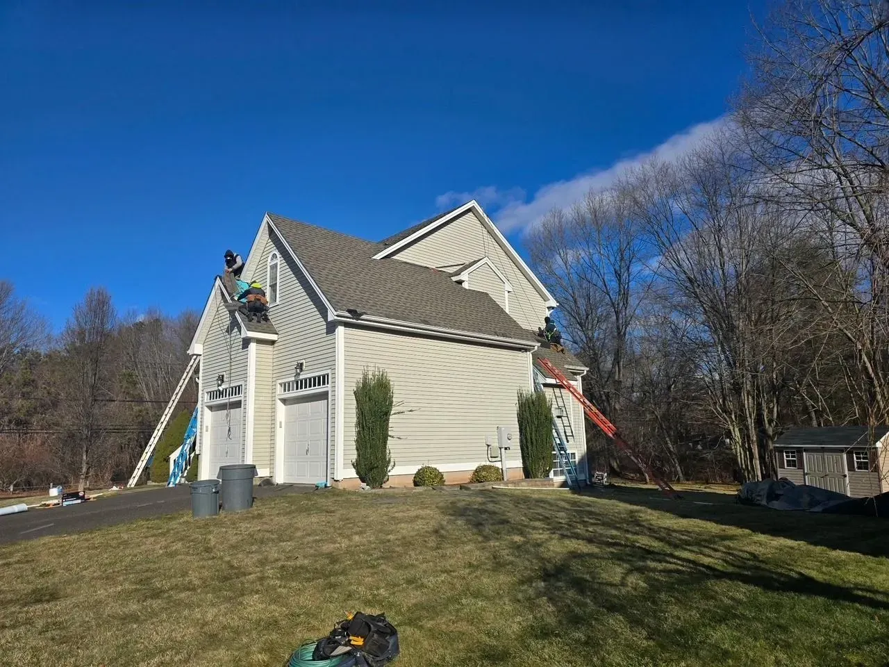 A man is working on the roof of a house.