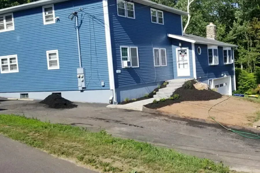 A blue house with a ramp in front of it