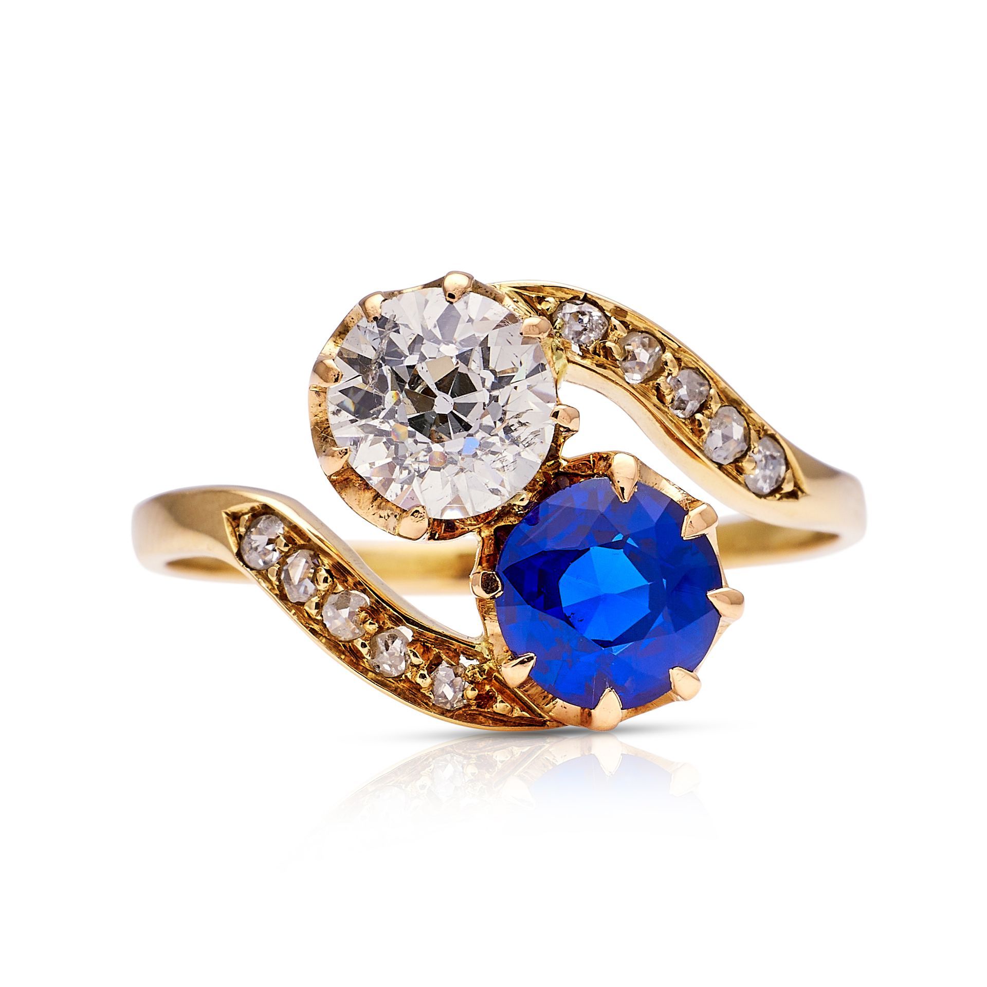 a gold ring with a sapphire and a diamond