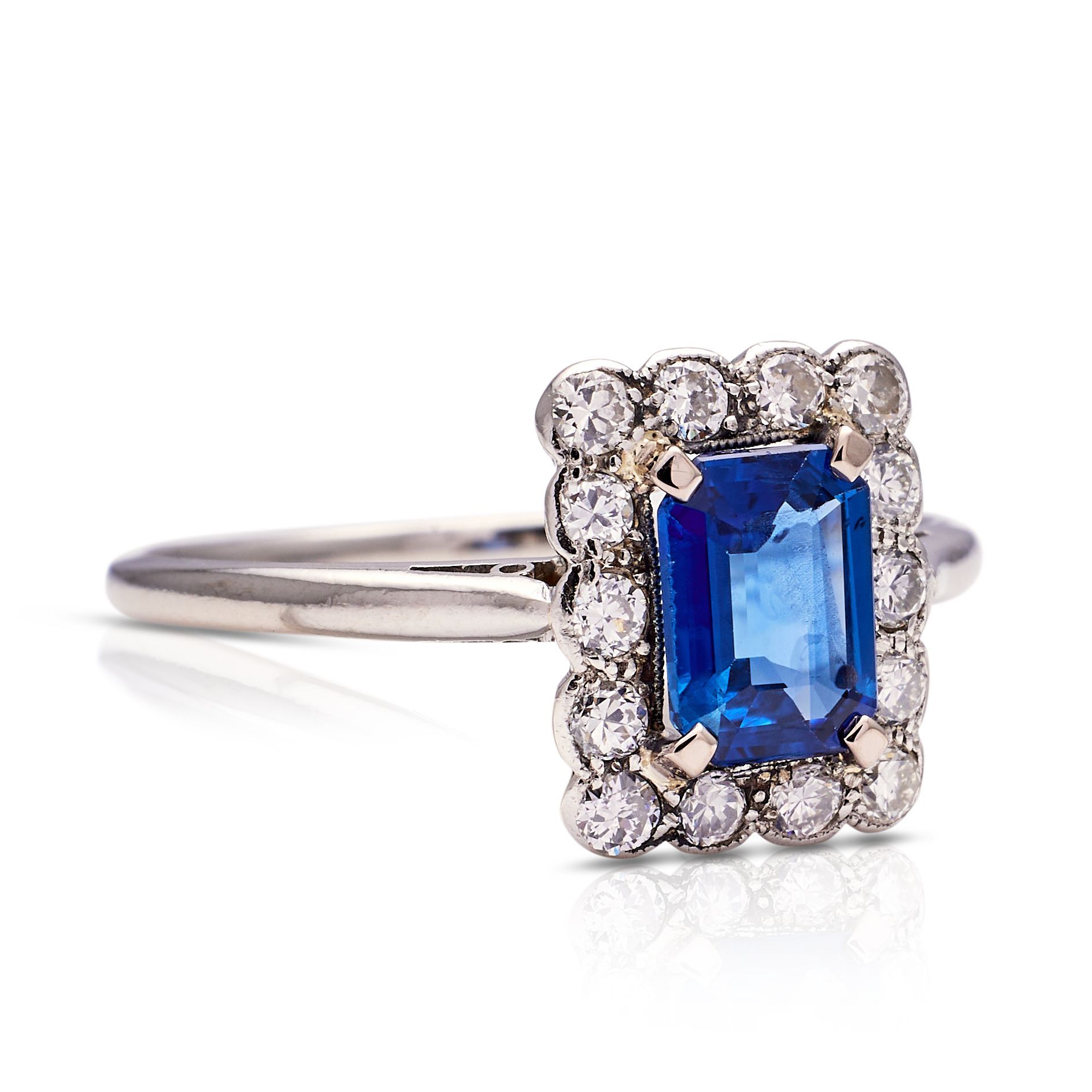 a ring with a square sapphire and diamonds