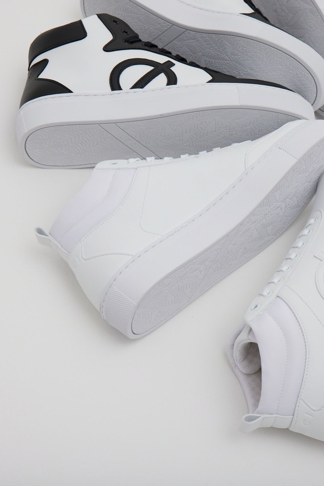 a close up of a pair of white sneakers on a white surface .