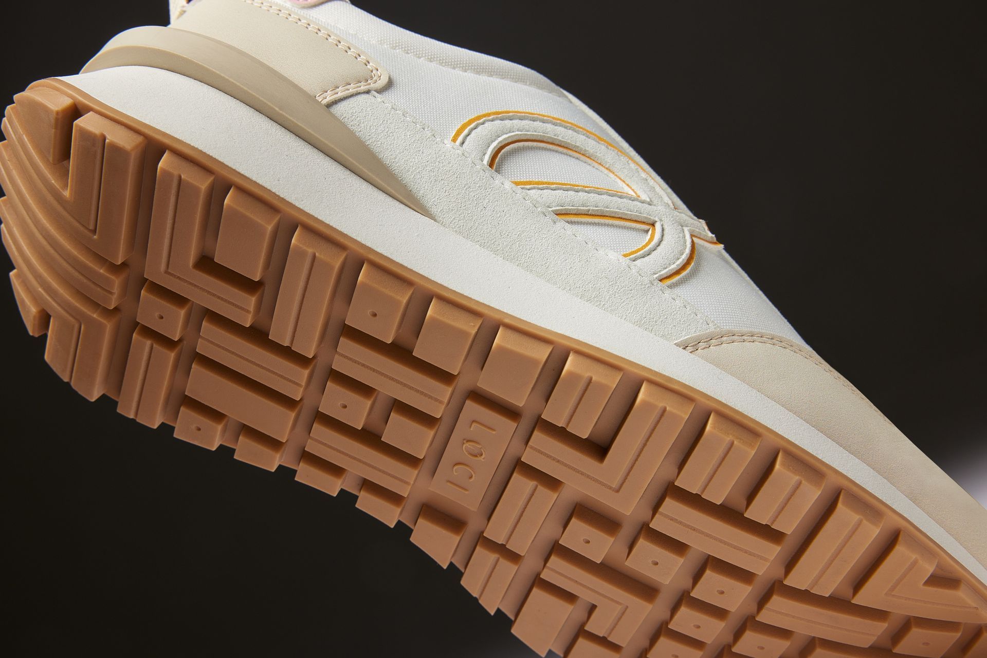 a close up of the bottom of a white shoe