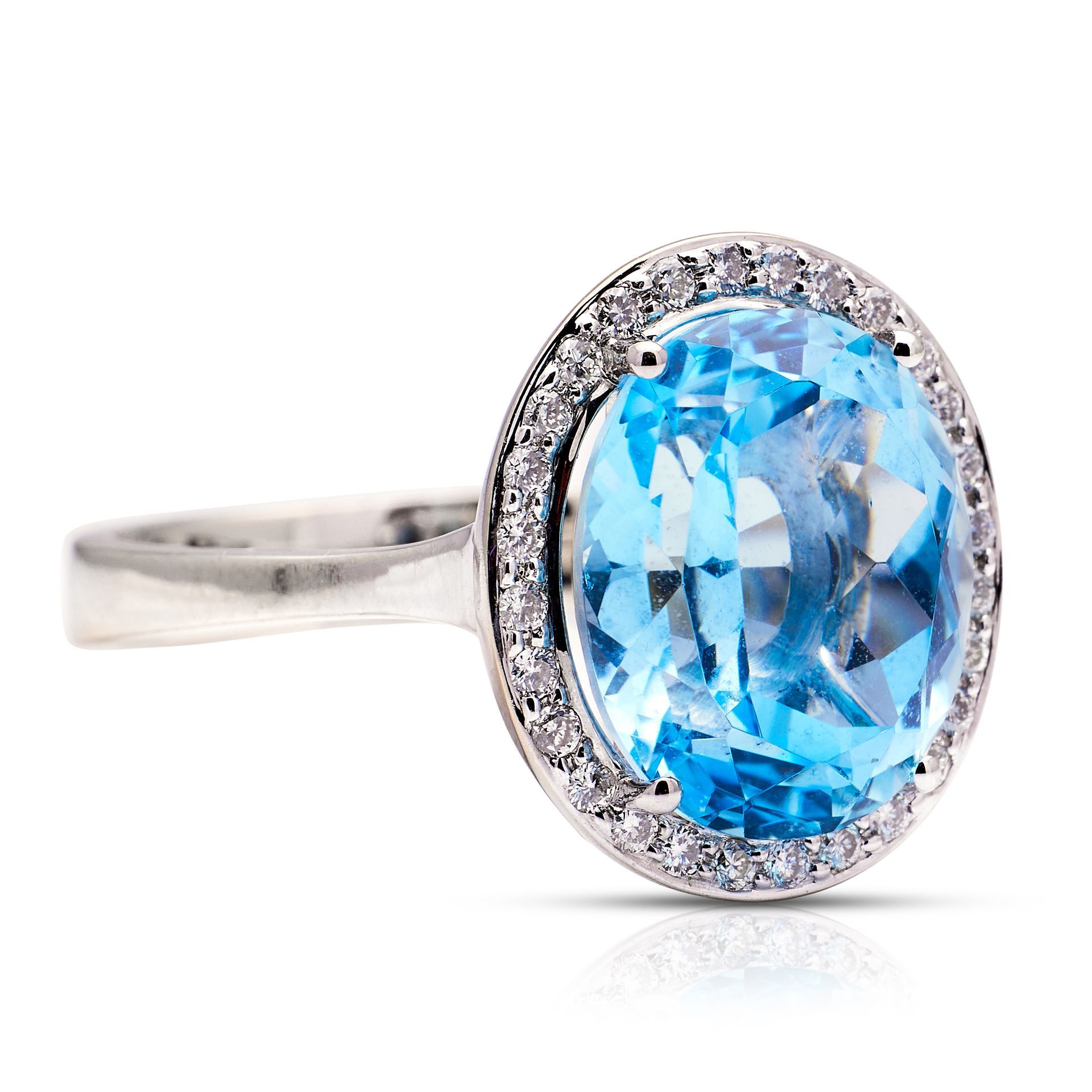 a white gold ring with a blue stone and diamonds