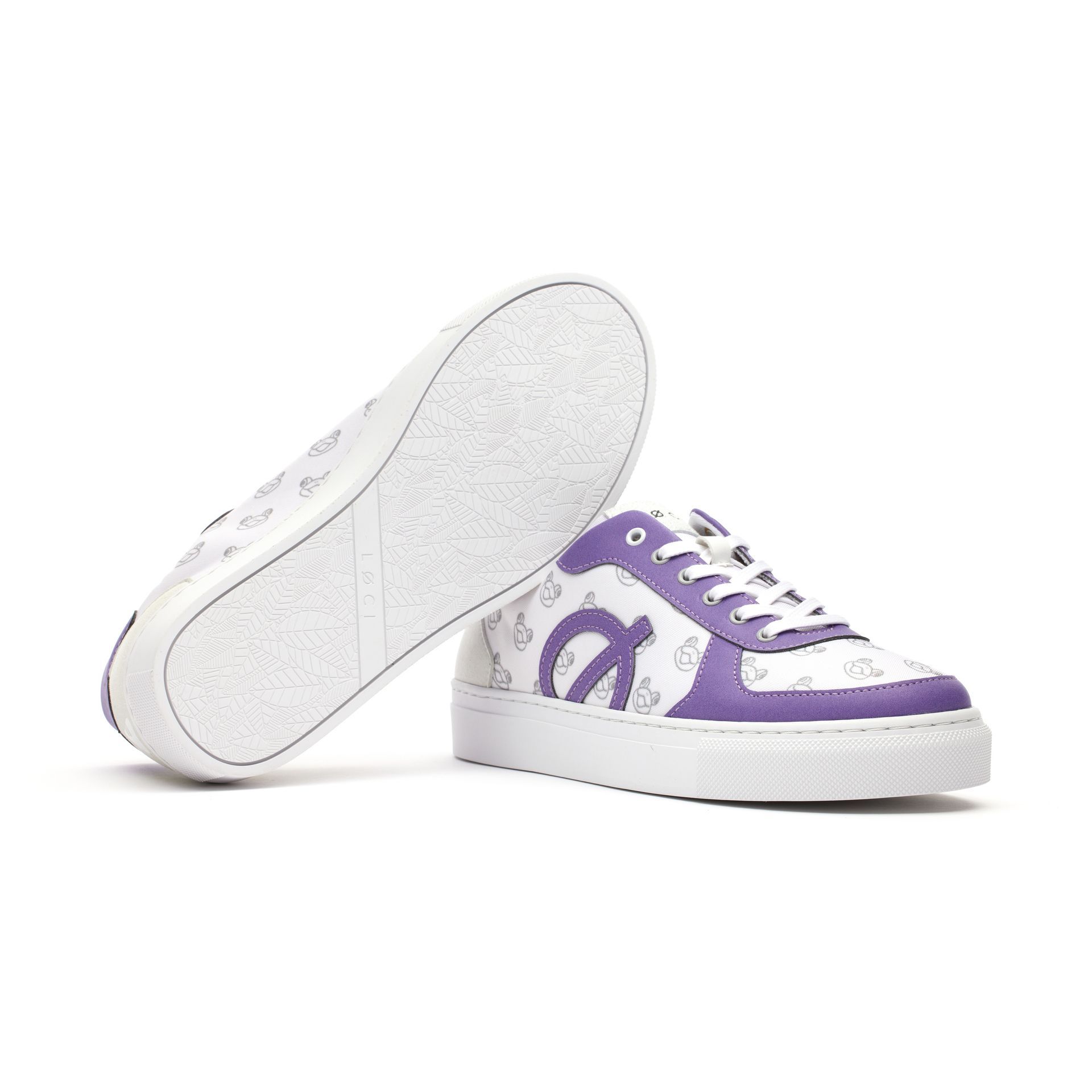 the bottom of a pair of white and purple sneakers on a white background .