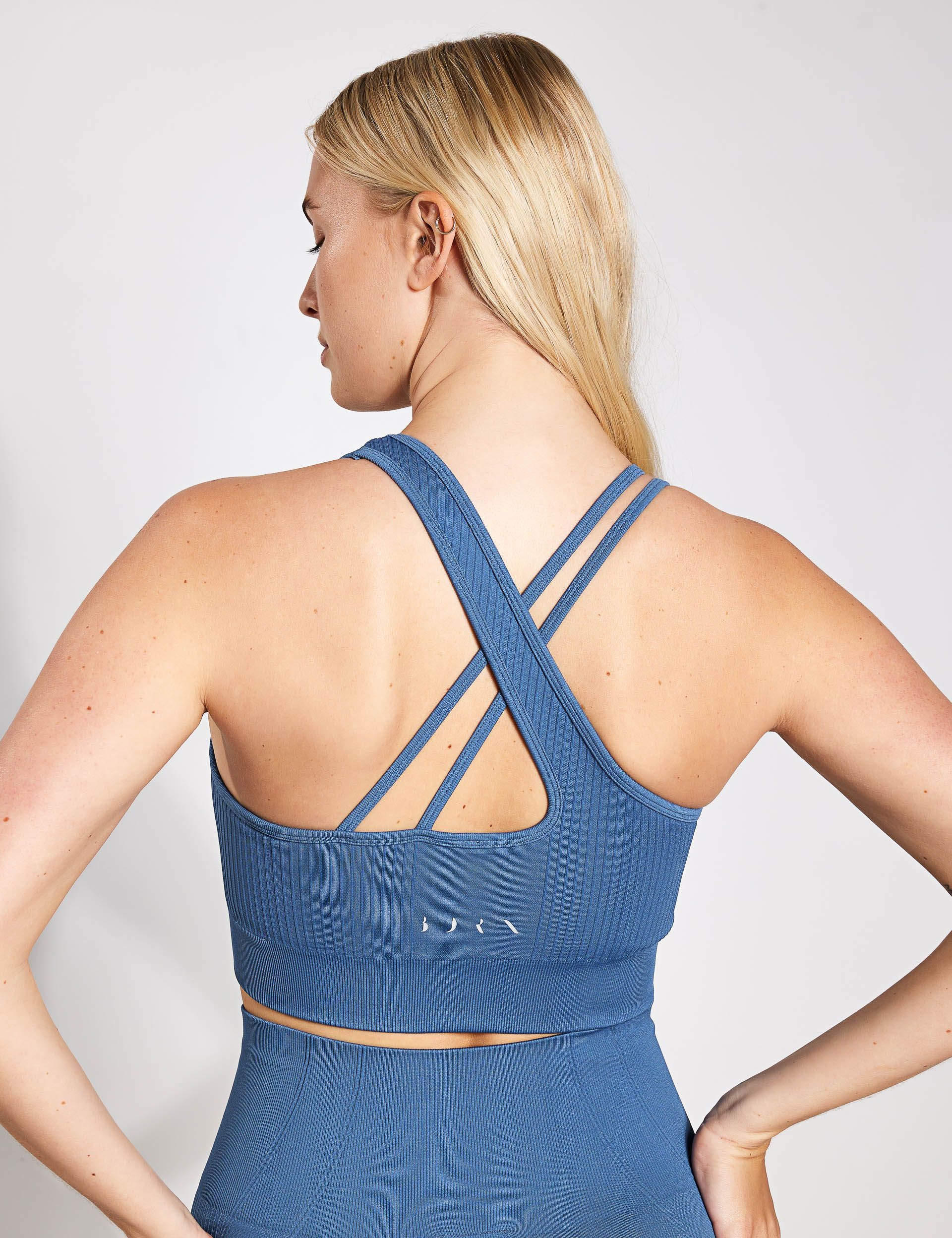 the back of a woman wearing a blue sports bra