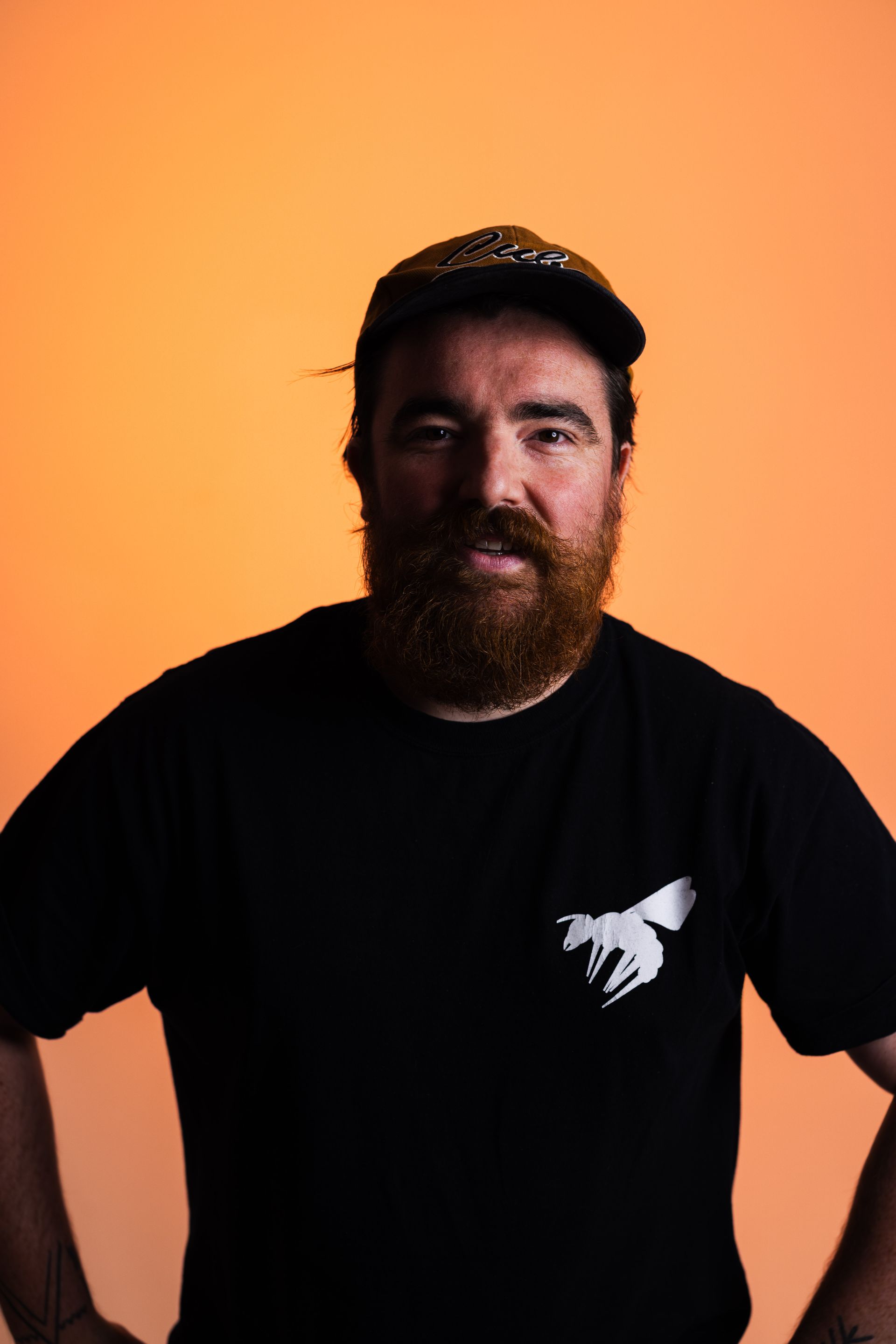 a man with a beard and glasses is wearing a maroon sweater .