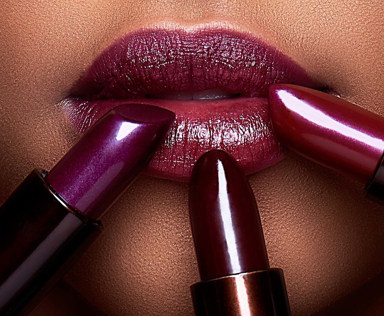 A close up of a woman 's lips with purple lipsticks