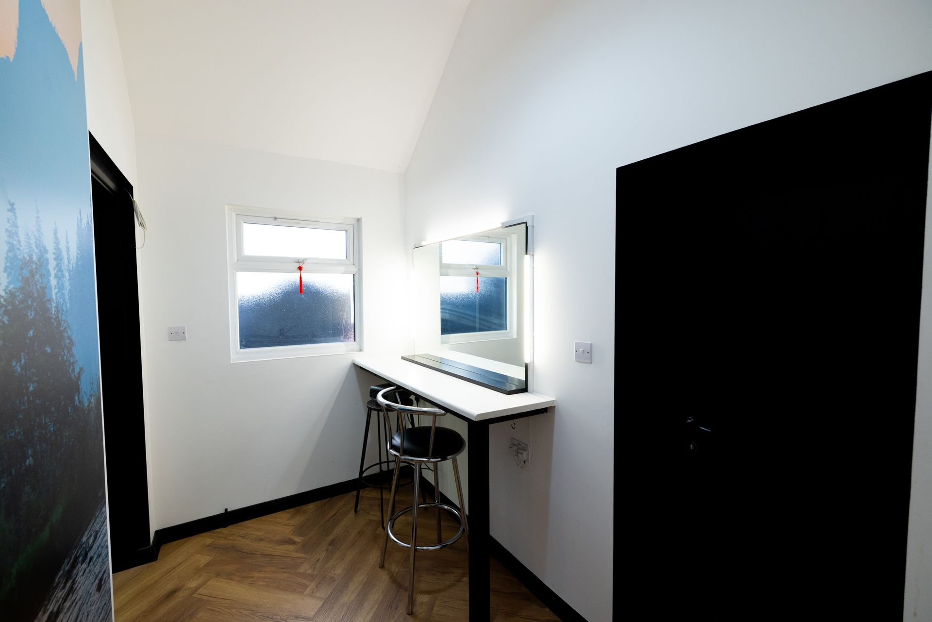 A dressing room with a mirror on the wall.