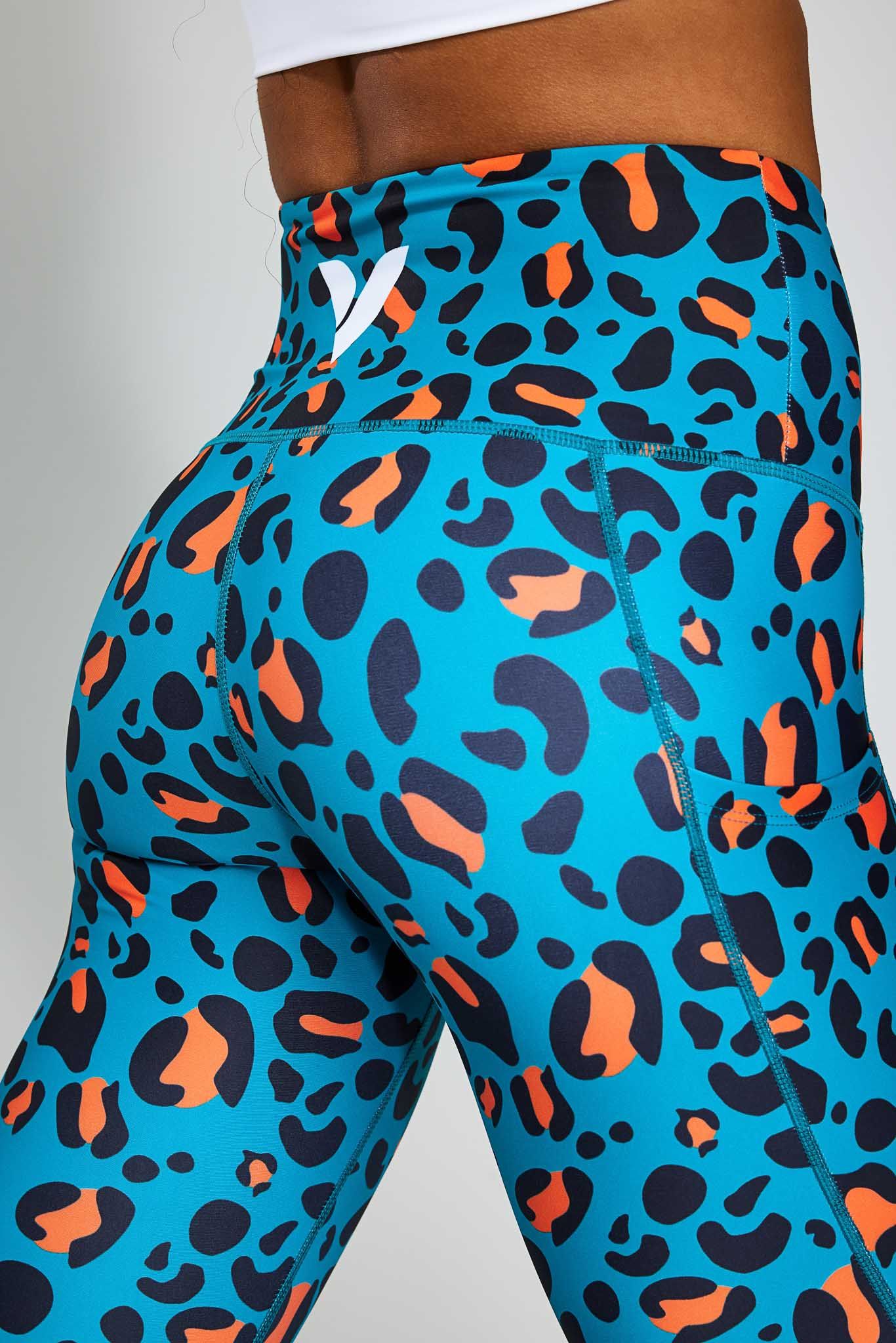 a woman wearing blue and orange leopard print leggings