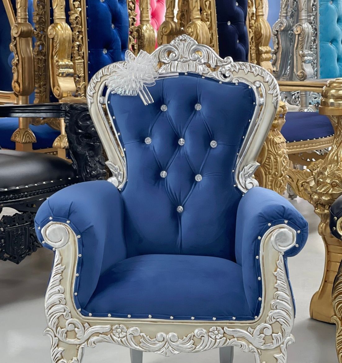 A blue and white chair is sitting in a room with other chairs.
