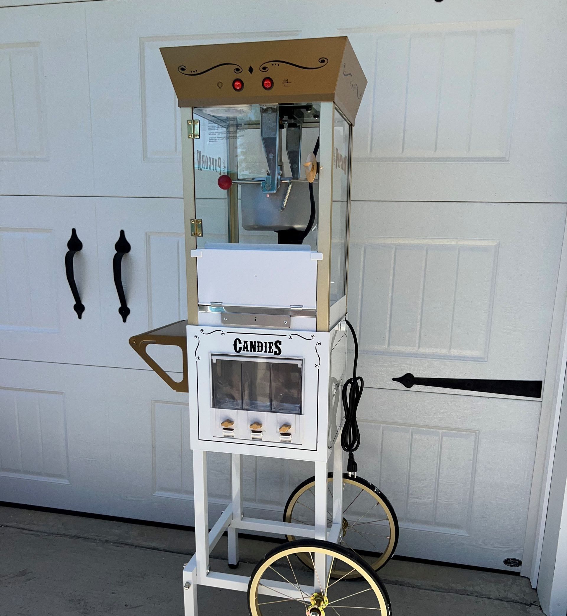 A gold chair is sitting in front of a popcorn cart.