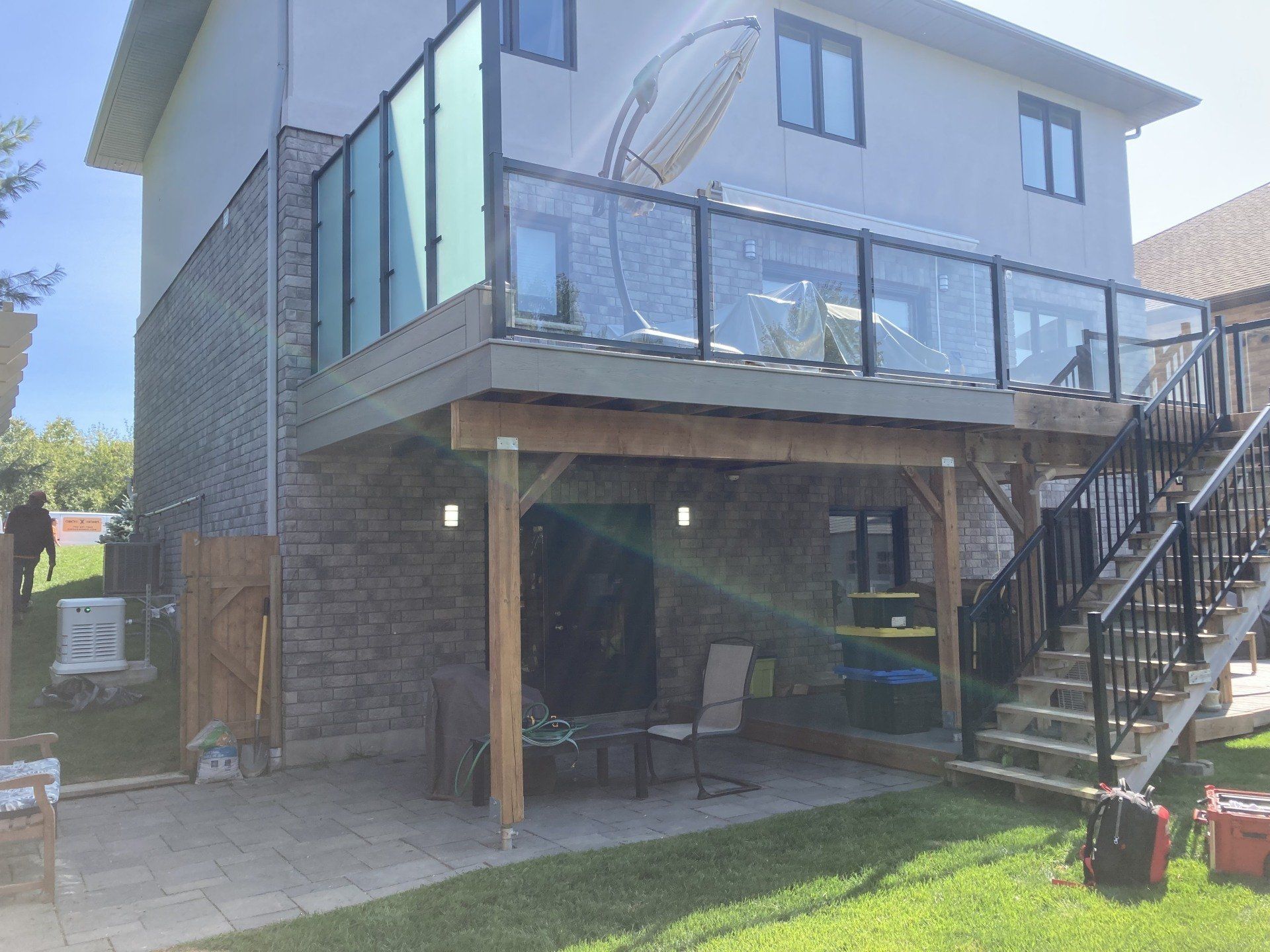 The back of a house with a large deck and stairs.